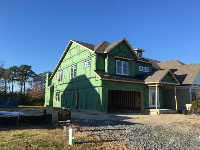 A coated OSB sheathing is taped at all seams to wrap the home in an airtight windbreaker.