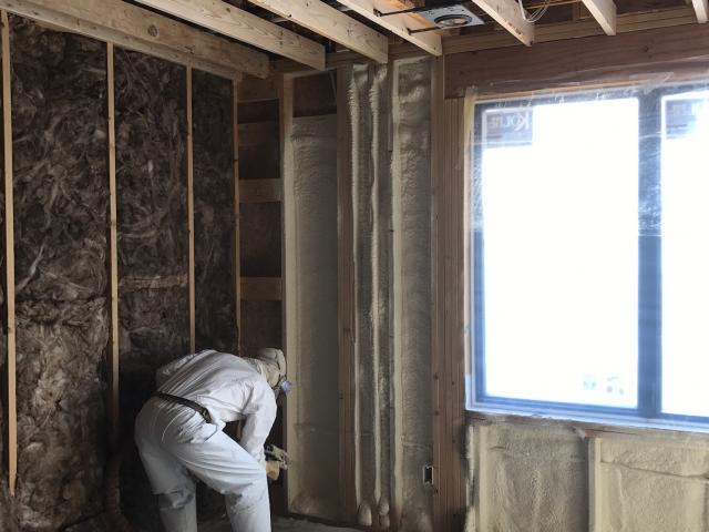 A high-density spray foam insulates and air-seals the wall cavities and also adds strength to the structure. Fiberglass will be added to completely fill the 2-by-6 walls, which will then be wrapped on the outside with 2 inches of rigid foam for a very substantial R-38 total wall insulation value.