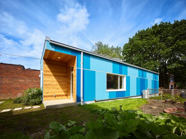 Brightly painted fiber cement panels provide a durable covering for the highly efficient home.