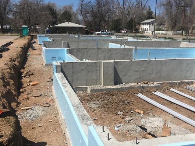 The slab-on-grade foundation is wrapped with R-10 insulation both under and around the slab.