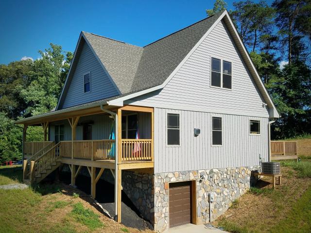 Under the architectural shingles and vinyl siding, a coated OSB sheathing product covers the roof deck and walls. With seams taped, it provides a continuous air and water barrier.