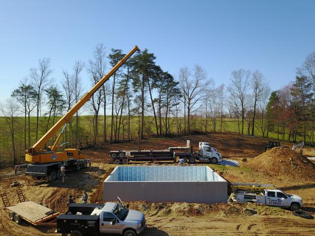 The insulated basement was constructed of precast concrete walls that come with a 2.5-inch layer of XPS rigid foam adhered to the inside of the walls and wrapping the metal-faced concrete studs.