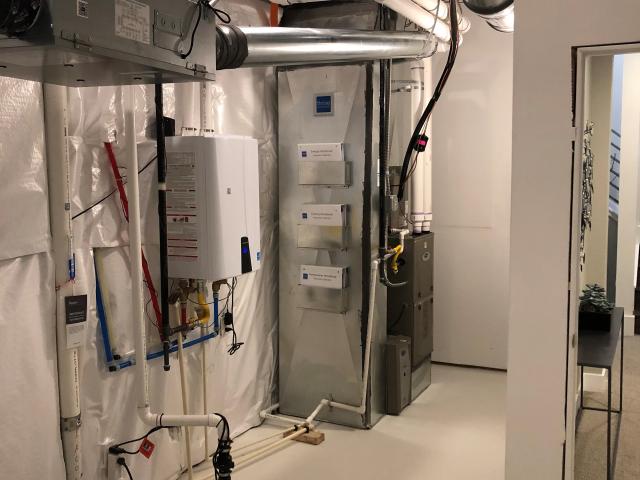 The utility room houses the home's high-efficiency comfort system, which includes a 12.5-HSPF, 18-SEER central air source heat pump and 0.95 AFUE gas furnace. It also houses the home's ERV, which is connected to sensors throughout the home to provide homeowners with a smart and responsive indoor air quality system.