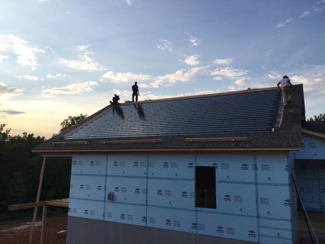 The 6 kW of solar shingles installed on the roof provide most of the home's power needs, reducing the already low HERS score from 41 without PV to only 13 with PV.