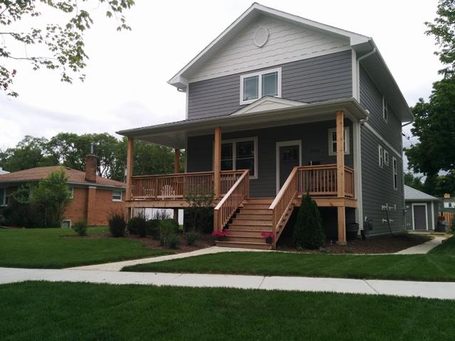 Deep overhangs, covered porches, and fiber cement siding help protect this Chicago area home from the elements.