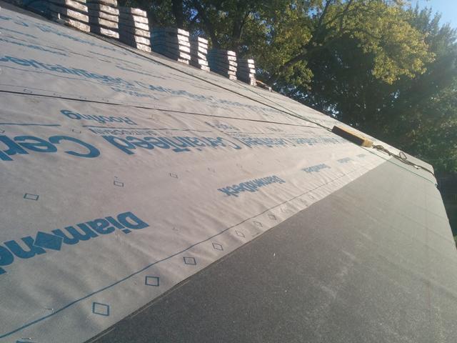 The roof is protected with coated OSB that is taped at all the seams then topped by 30-lb. roofing felt and a water-proofing membrane at all eaves to provide continuous water protection under the light-colored asphalt shingles.