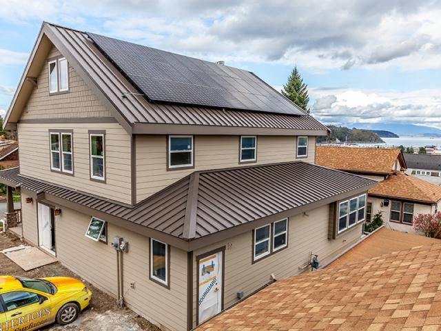 While the east side of the home captures Puget Sound views, the south-facing roof captures solar energy via a 10.89-kW photovoltaic array.