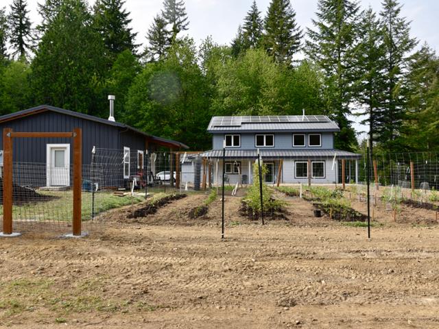 The south-facing roof is covered with 8.1 KW of photovoltaic panels, helping this home to produce more energy than it uses in a year.