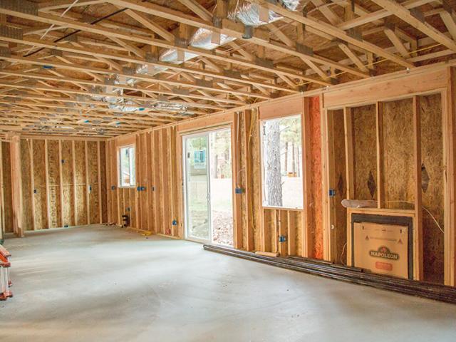 The home’s 2-by-6, 16-inch on-center walls are sheathed with 7/16-inch OSB and filled with open-cell spray foam then covered with house wrap.