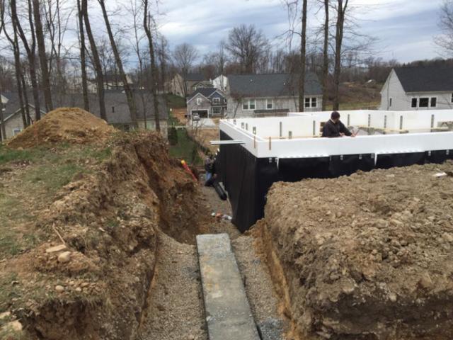 The basement walls are made of ICF blocks that provide continuous layers of insulation along the interior and exterior of the foundation walls, while dimpled plastic mats shed water away from the structure.