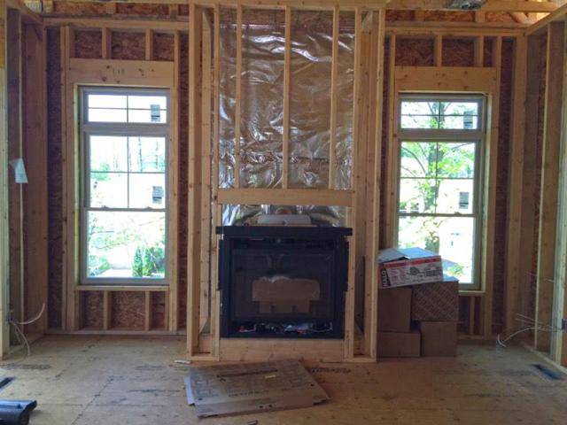 The foil-faced insulation behind this fireplace provides an air barrier and thermal shield.