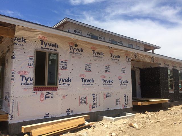 Taped house wrap provides an air and water barrier over OSB sheathing on the 2-by-6 advance-framed walls, which are dense packed with blown fiberglass and air-sealed with a sprayer-applied sealant.