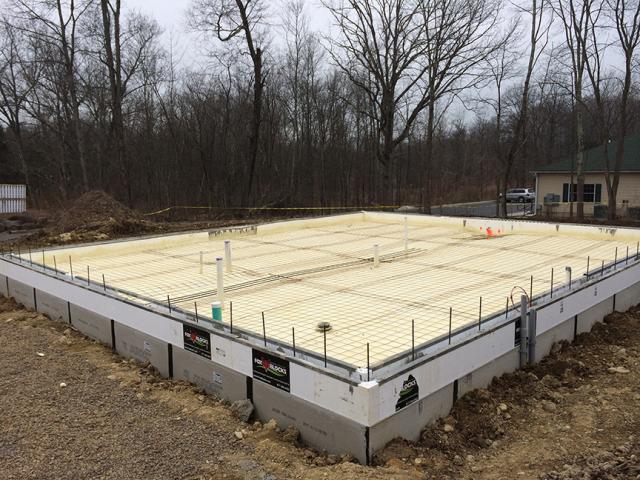 ICF walls wrap the floor slab in R-22 of insulation while the entire space under the slab was covered with 4.3 inches of closed-cell spray foam.