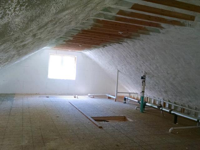 The attics are insulated to R-64 with a hybrid application of 11 inches of open-cell spray foam (R-4.45/in) plus 2 inches of closed-cell spray foam (R-7.4/in) that completely fills the roof rafter cavities and encases the rafters creating a continuous blanket of insulation across the attic ceiling.