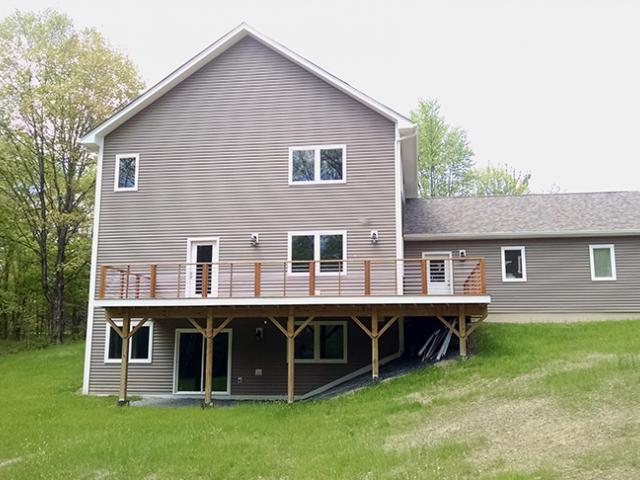 A daylight basement and insulated attic mean three floors of living space plus storage in the compact structure.