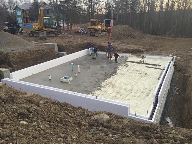 The basement slab is wrapped in a blanket of insulation including R-27 of closed-cell spray foam under the slab and R-22 ICF blocks wrapping the slab edges.