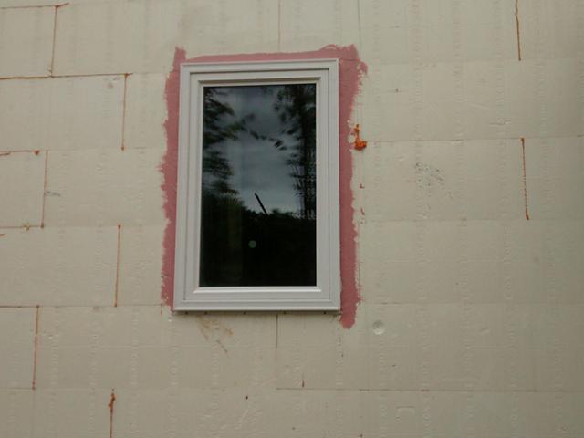 Before installing the triple-pane vinyl framed windows, the window rough openings are sealed with a liquid-applied flashing that provides a seamless moisture and air barrier to protect the wall from moisture intrusion.