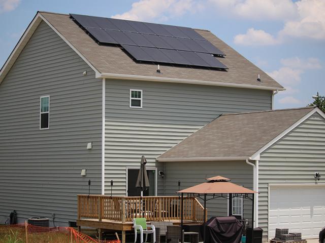 Rooftop solar panels come standard on the production homes in this community by Health-E Community Enterprises.