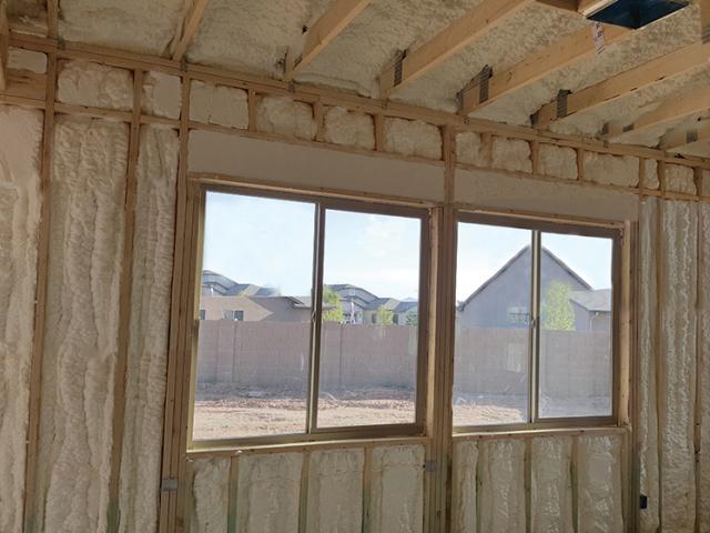 Spray foam fills the cavities of the advance framed 2-by-6, 24-inch on-center walls and lines the roof deck of the unvented attic.