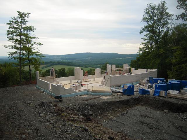 The home's above-grade walls are made of 8-inch-thick aerated autoclaved concrete (AAC) blocks. AAC is formed by mixing fine aggregate with water and other minerals that form gas bubbles in the mix causing it to double in size. It can be molded, fired, and easily cut into lightweight blocks with structural and insulating properties.
