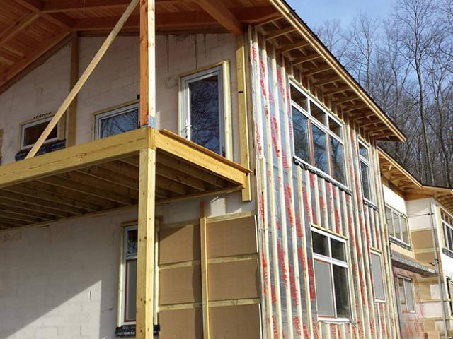 On the exterior of the aerated concrete walls, the builder attached 4.5 inches of foil-faced polyisocyanurate rigid foam and topped this with furring strips to provide a ventilation gap behind the fiber cement siding.