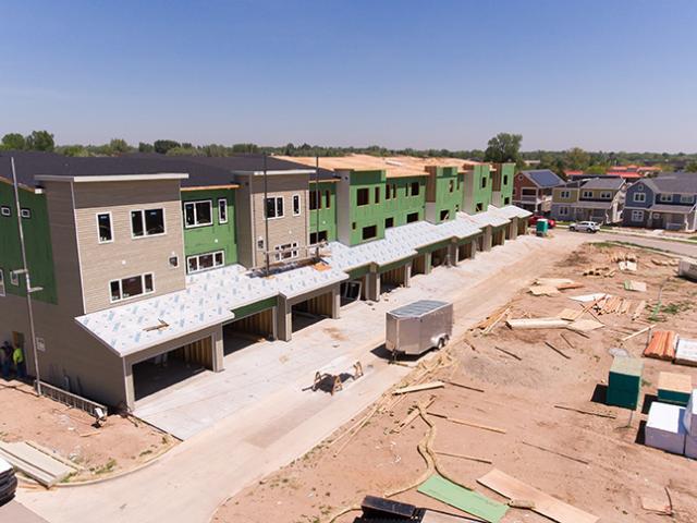 Coated OSB wall sheathing with taped seams replaced house wrap as the continuous drainage plane and air barrier behind the siding.