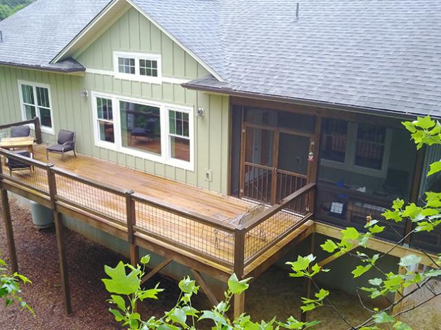 The sloped lot, stone base, perimeter drain, and vapor retarder help to keep moisture out of the insulated basement.