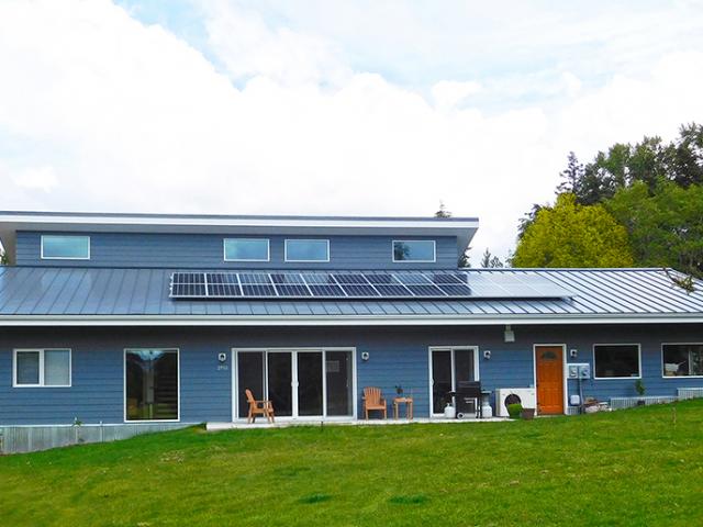 Metal roofing and fiber cement siding provide a durable exterior for this marine climate home.