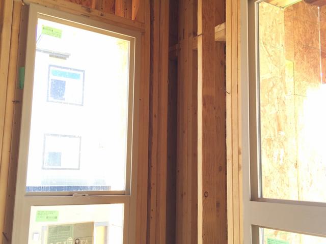 Open corners and open headers above windows are some of the advanced framing features that reduce lumber use and leave more space in the wall for insulation.