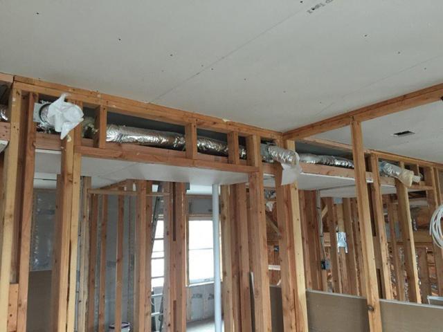 The HVAC ducts are located inside the home in dropped ceiling chases where they are protected from the elements.