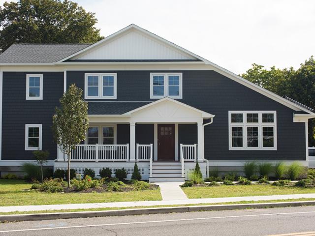 Beneath the durable PVC siding, the 2-by-6 framed walls are filled with 5.5 inches of dense-packed cellulose then wrapped with 1.5 inches of rigid foam and covered with coated OSB with taped seams to provide a continuous air and moisture barrier around the home.