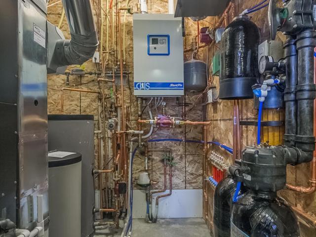 The home's high-efficiency gas boiler provides domestic hot water as well as in-floor radiant heat, while a high-efficiency heat pump provides cooling and a secondary source of heating.