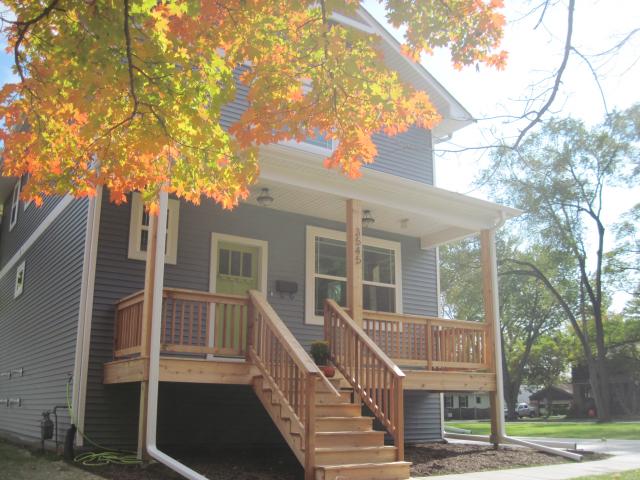 Downspouts and proper grading help ensure water drains away from the two-story home.