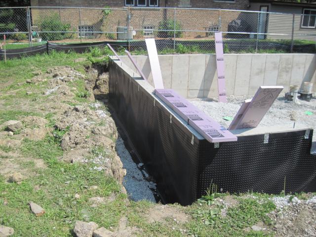 A plastic drainage mat helps ensure water drains down the outside of the concrete foundation wall to the footing drains. The mat is installed over a continuous exterior thermal blanket composed of two 1.5-inch layers of rigid foam insulation that maximize comfort and minimize the risk of moisture problems.