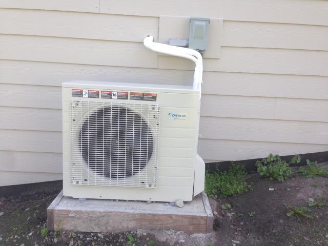 This compact outside unit for the ultra-efficient air-to-water heat pump (COP 4.1) provides space heating and domestic hot water. The heat pump could also provide cooling, but the house is designed so that thermal mass and ventilating exhaust fans with timer controls remove most of the unwanted heat from the home during the few high-temperature days in the mild Northwest climate.