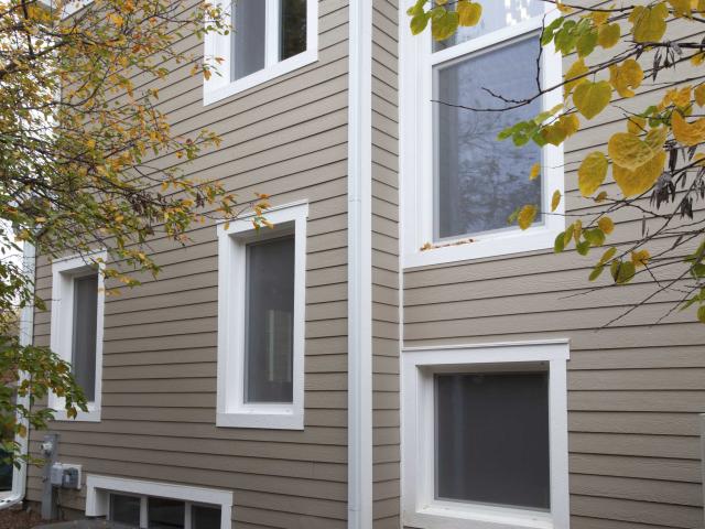 A durable engineered wood siding covers the exterior of the ultra-efficient home. Proper site grading carries water away from the foundation, which is also protected by a liquid-applied waterproofing membrane and continuous thermal blanket composed of two 2-inch layers of XPS rigid foam on the exterior of the wall, under the slab, and between the slab and footing.