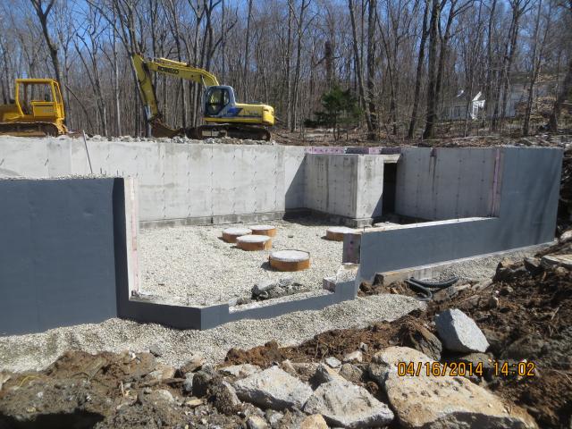 The ultra-efficient foundation insulation system includes 10-inch-thick concrete foundation walls with a 4-inch layer of rigid XPS foam (R-20) sandwiched between two layers of concrete and 5 inches of FOAMGLAS (R-17) underneath the slab.