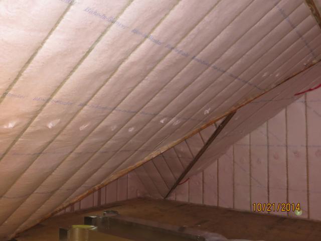 The high-efficiency attic insulation includes 5 inches of closed-cell spray foam on the underside of the roof deck plus 6.5 inches of blown fiberglass covered with sheetrock as a firebreak for a total R-58 roof assembly insulation value.