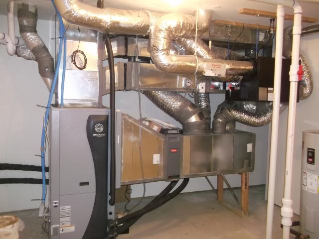 The ultra-efficient (COP 5.7) ground source heat pump uses a central air handler with modulating condensers and a variable-speed electrically commutated motor blower.