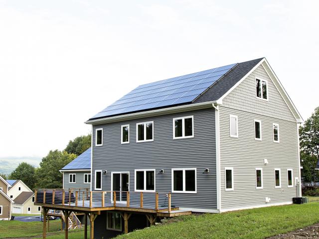 The roof-mounted 10.08-kW solar electric system meets most of the electricity needs of this high-efficiency home, cutting homeowners' electric bills to less than $300 per year.