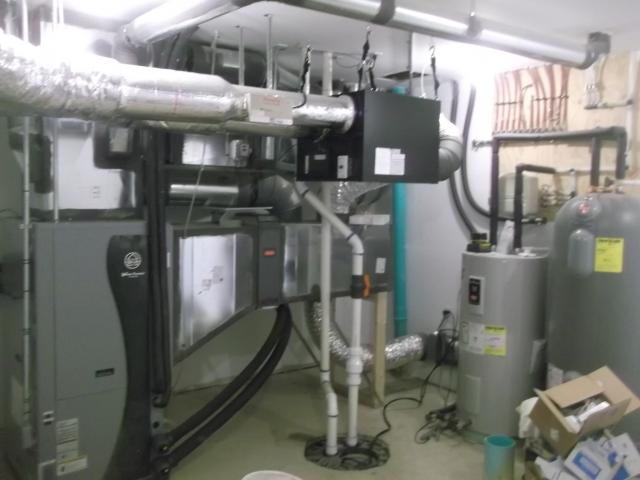 The ultra-efficient (COP 5.7) ground source heat pump uses a central air handler with modulating condensers and a variable-speed electrically commutated motor blower to distribute conditioned air. The balanced fresh air system uses an energy recovery ventilator connected to the air handler to provide filtered fresh air to the home. A desuperheater on the heat pump provides a portion of the domestic hot water.