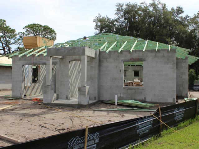 The hip roof design, concrete block construction, and a sealed attic all help to make the home more storm resistant.