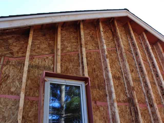 A second wall cavity was created on the outside of the exterior walls by first constructing 2-by-6, 24-inch on-center walls with plywood sheathing then attaching 8-inch engineered truss joists to the outside of the plywood and installing a second wood-and-resin sheathing over that. The 5.5-inch and 9.5-inch wall cavities were then filled with dense-packed cellulose for a total wall insulation value of R-60.