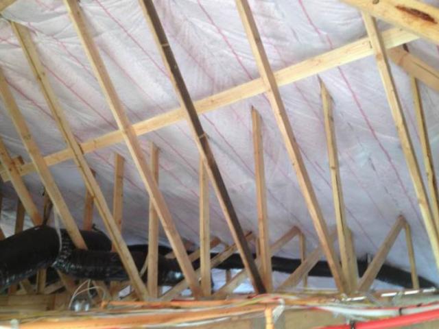 The attic is insulated at the underside of the roof deck with R-38 of blown fiberglass, providing a conditioned space for the comfort system's heating and cooling ducts.