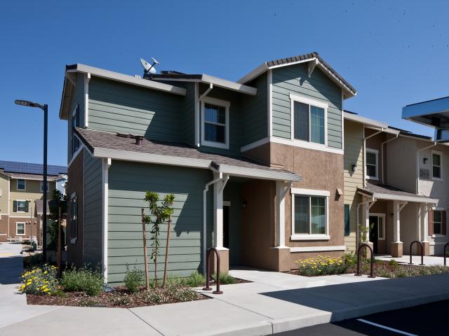 Deep overhangs and entry porches, a radiant barrier in the attic, and advanced window technology coatings on the glass help to minimize solar heat gain in the apartments.