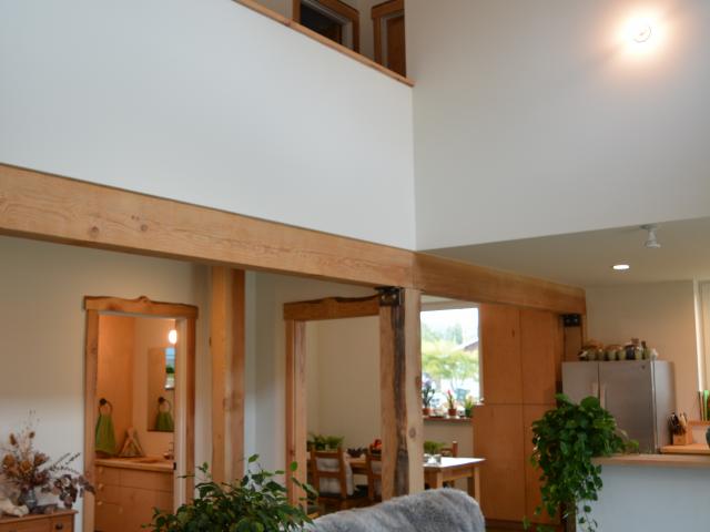 The open floor plan encourages transfer of heat from the thermal mass concrete floors to the second-floor living spaces while lighting the interior of the home with natural daylight.