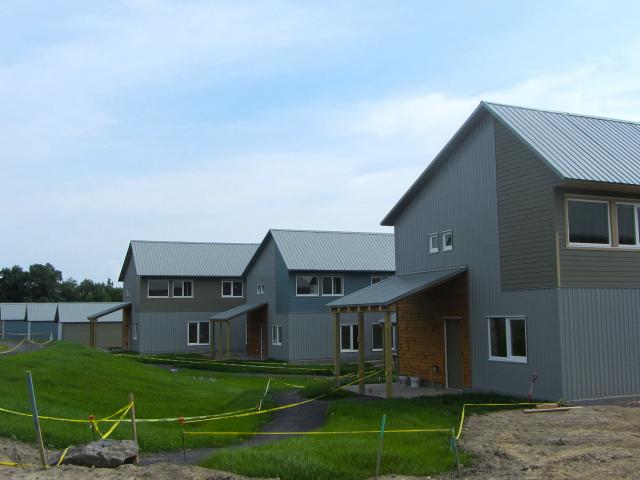 The home's whole-house water protection system includes durable weather-resistant metal roofing and fiber cement siding, while the site is graded to slope away from the foundations, with bios-wales, permeable paving, retention ponds, and rain gardens planted with native species that naturally drain storm water from the site.