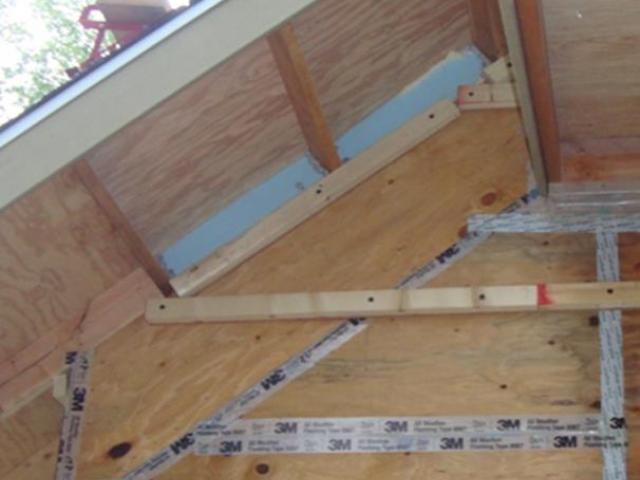 Taping the plywood sheathing seams is one step in the comprehensive draft protection scheme.