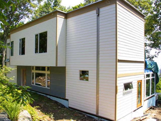 Under the home's fiber cement siding is a combination of house wrap, furring strips, and plywood sheathing that work to direct water away from the home to achieve a complete dry-by-design construction.