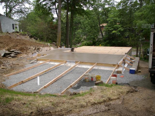 A slab foundation was added next to the existing uninsulated staggered-height basement, doubling the size of the home's original footprint. The new slab was poured over an ultra-efficient R-55 rigid foam foundation insulation.